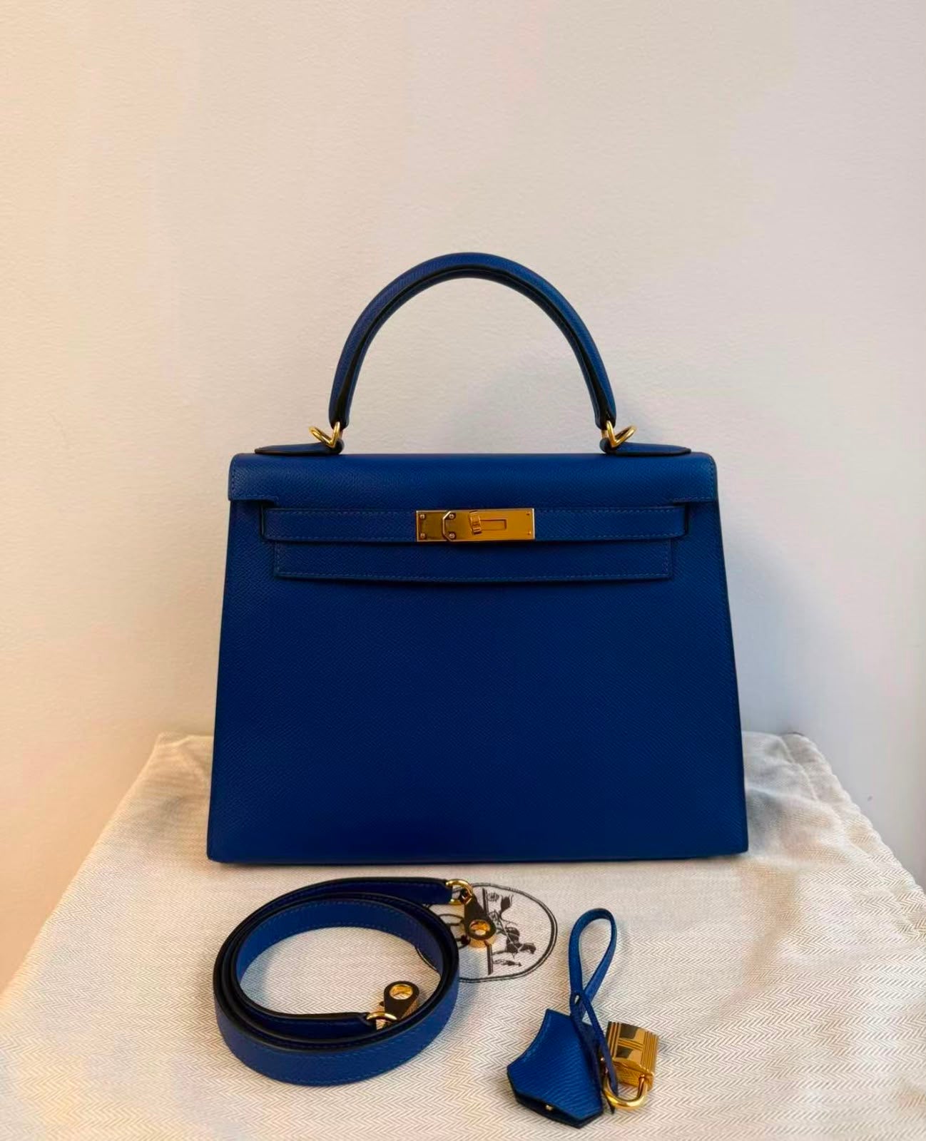Blue top-handle bag with gold-tone hardware